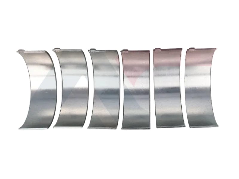 Set of metal engine bearings on a white background