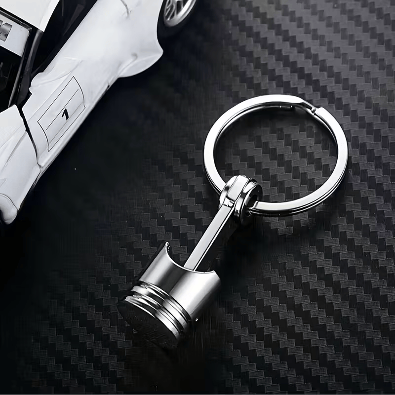 Car Engine Piston Keychain On Carbon Fibre Style Background HR3610276